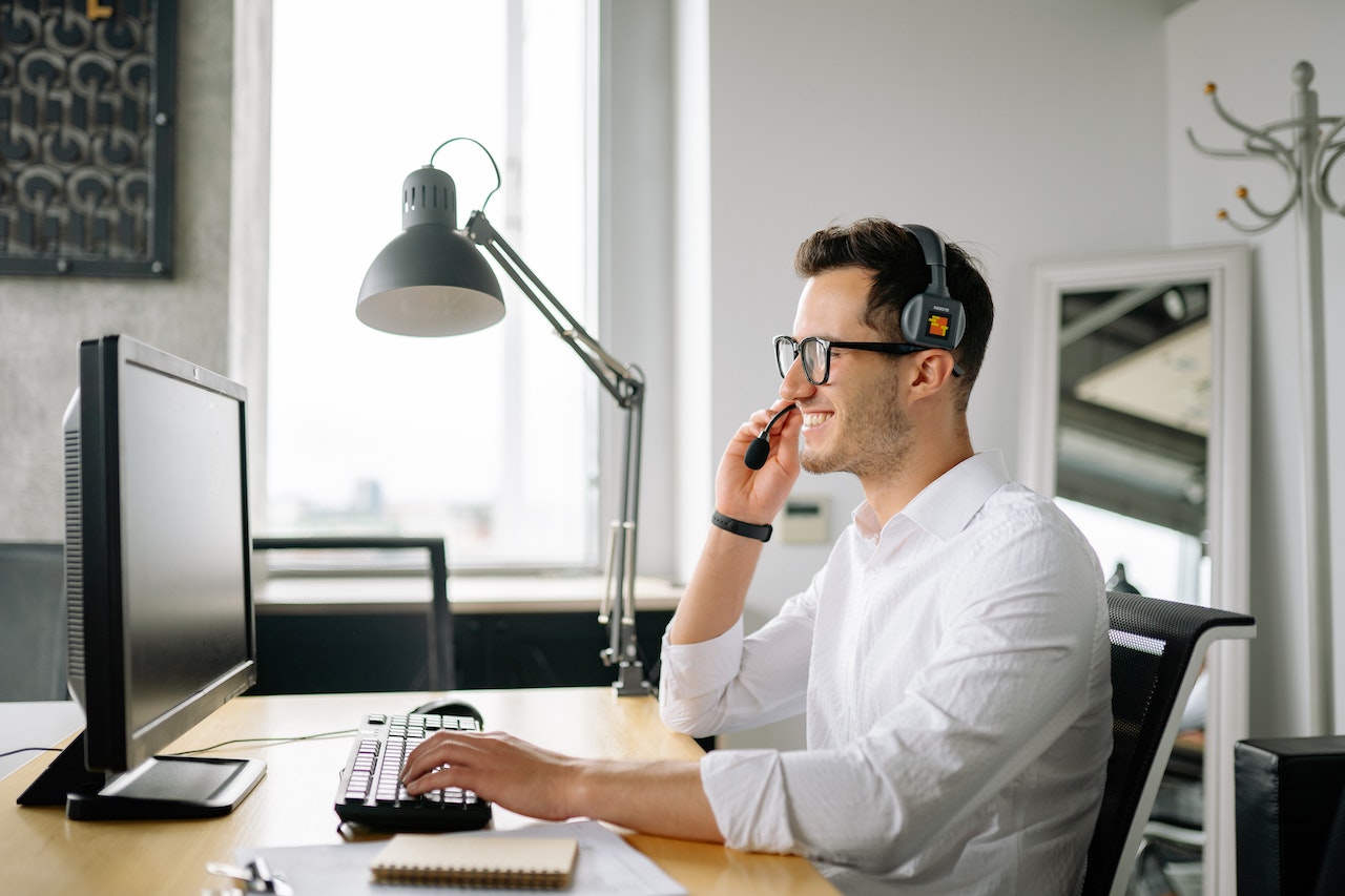 a customer support agent in front of a computer