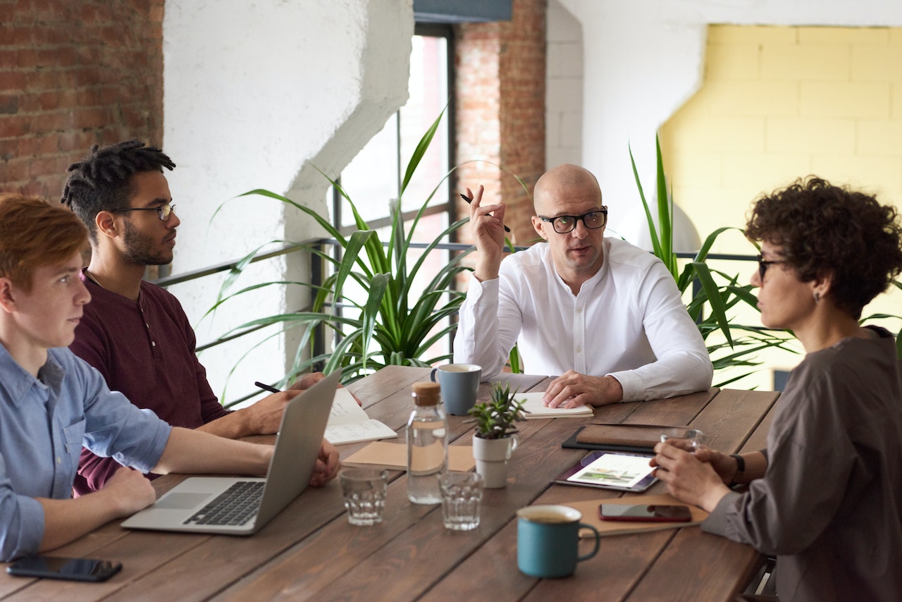 people sitting at a desk at a business meeting