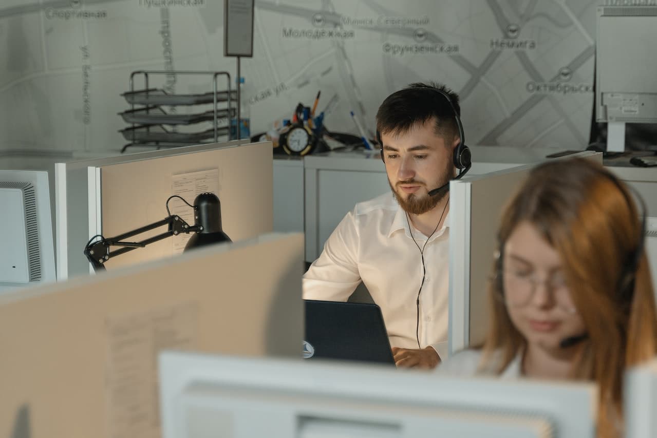 a man sitting in front of a computer in an open space